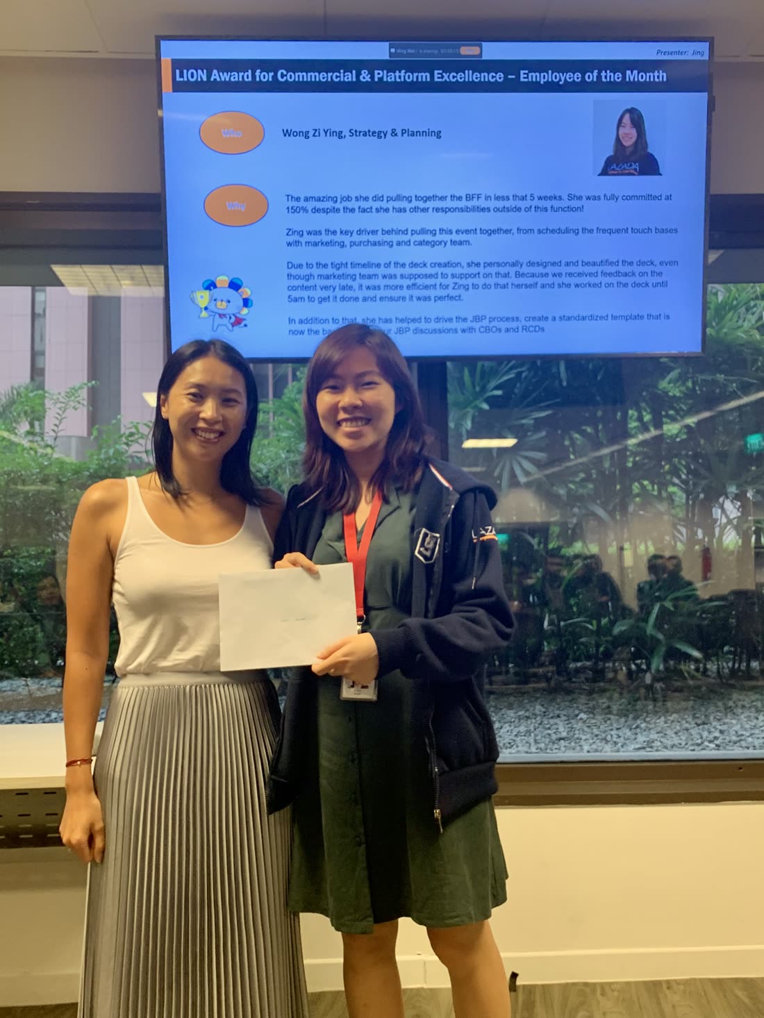 Zing receiving the LION Employee of the Month award at Lazada